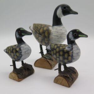 three carved wooden ducks
