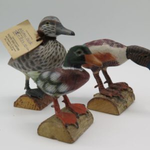 three carved wooden ducks