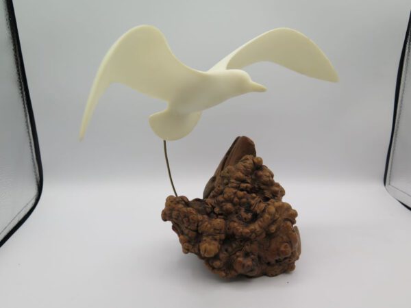 seagull figurine on wood
