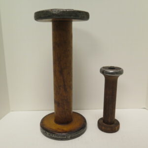 two industrial thread spools. made from wood and metal