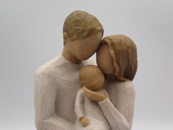 figurine of couple with newborn